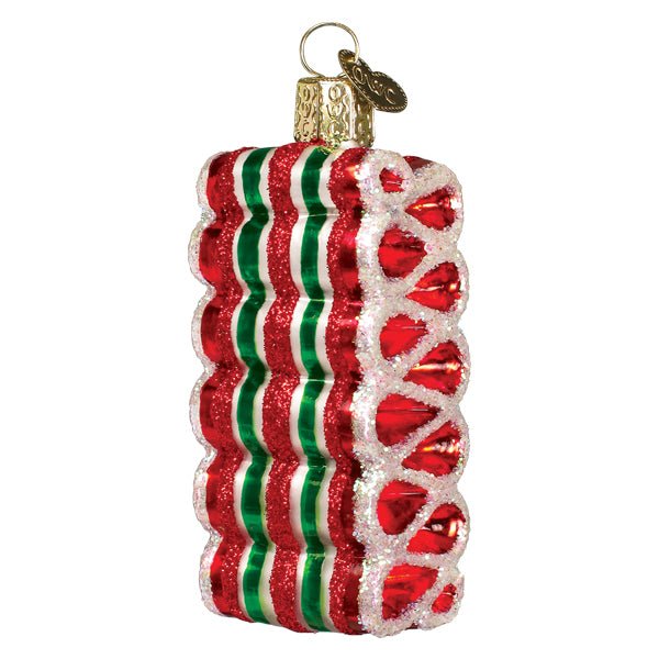 Red, white, and green striped ribbon candy glass ornament with gold cap, front view on white