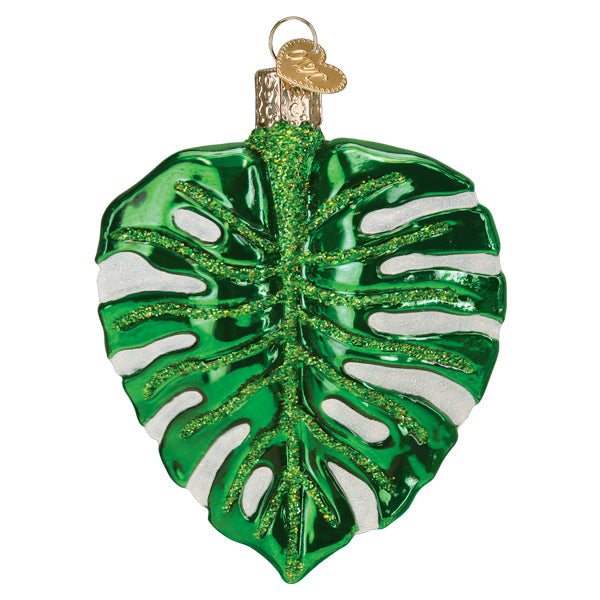 Front of the glossy green monstera leaf ornament with glittered veins and white splits, on white
