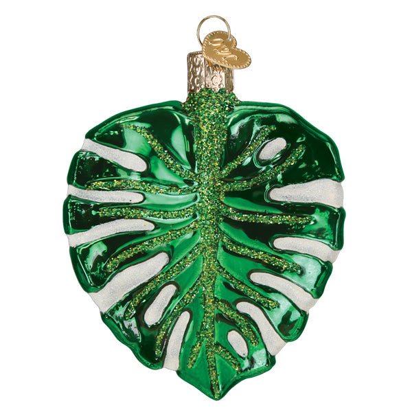 Back of the monstera leaf ornament showing the green leaf and white splits from behind, on white
