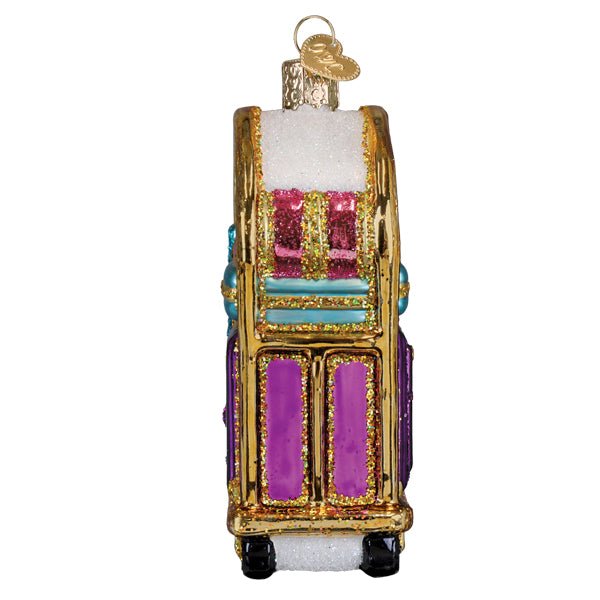 Side view of the luggage cart ornament showing stacked bags and black wheels