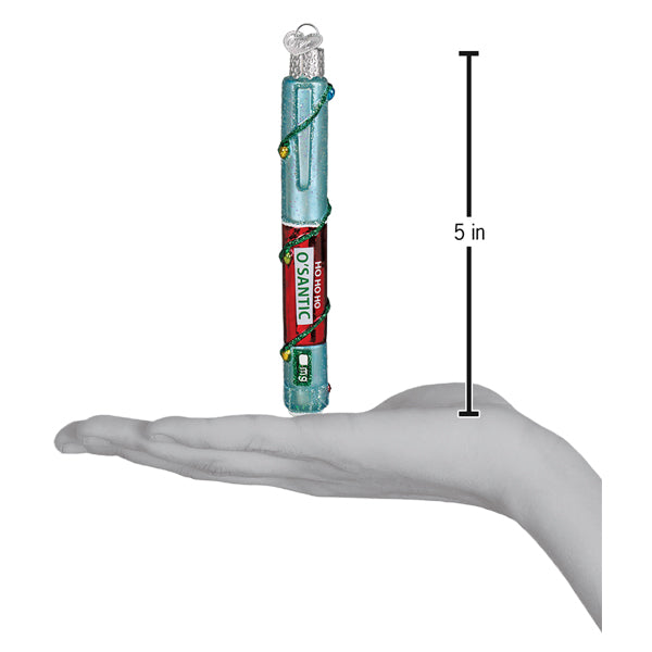 Injection pen ornament held above an open palm with a 5 inch height marker for scale