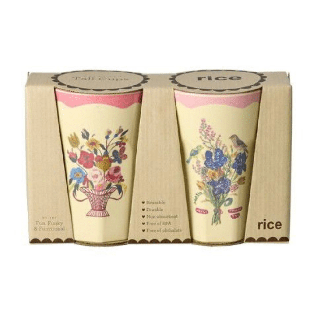 Two Nathalie Lété tall melamine cups with different floral bouquets and pink rims inside a windowed kraft gift box