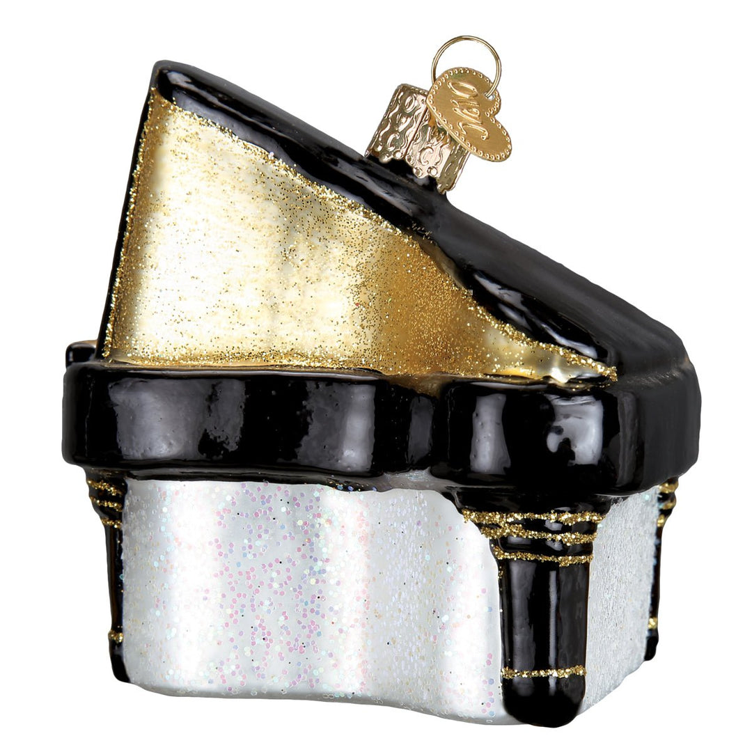 Back of the piano ornament with the gold glittered lid propped open, on white