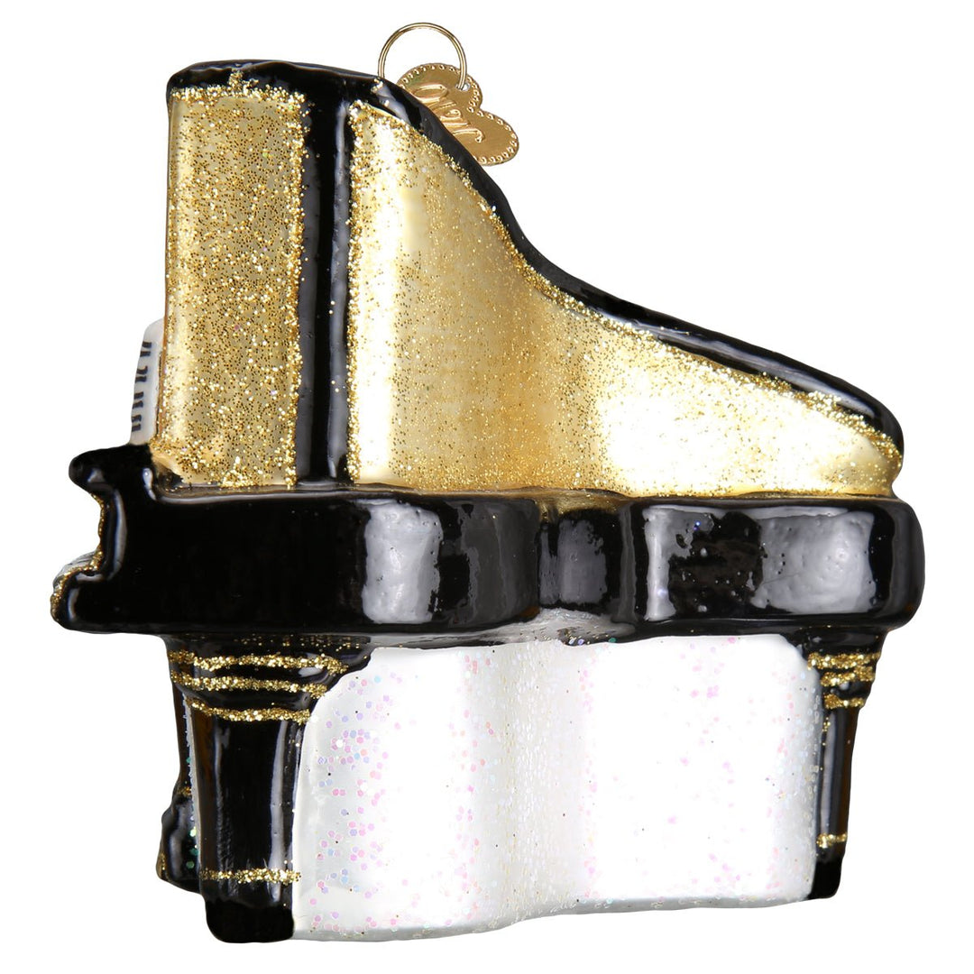 Side view of the baby grand piano ornament with its curved gold lid and black legs