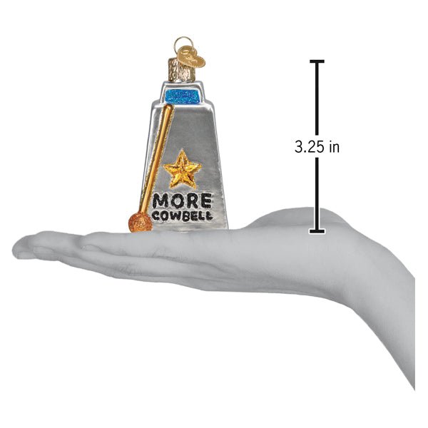 More cowbell ornament on an open palm beside a 3.25 inch height marker
