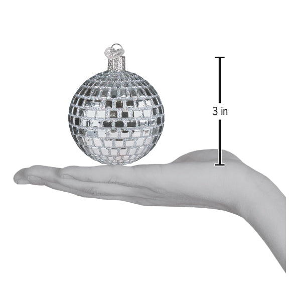 Silver disco ball ornament on an open palm beside a 3 inch height marker
