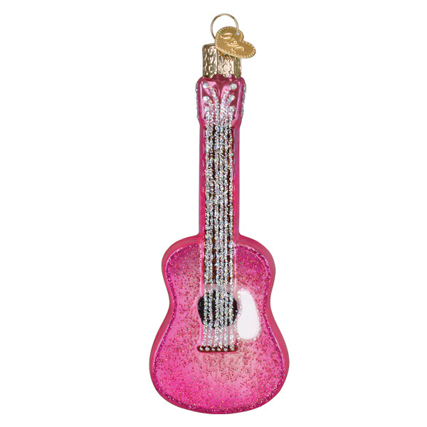 Pink glitter acoustic guitar ornament with silver strings and a white pickguard on a white background