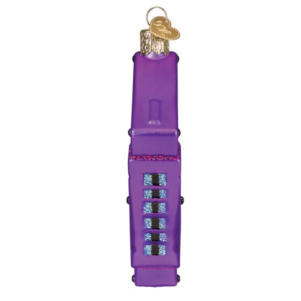Edge view of the purple cassette tape ornament showing its spine detail, on white