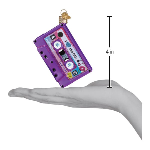 Purple cassette tape ornament on an open palm beside a 4 inch height marker