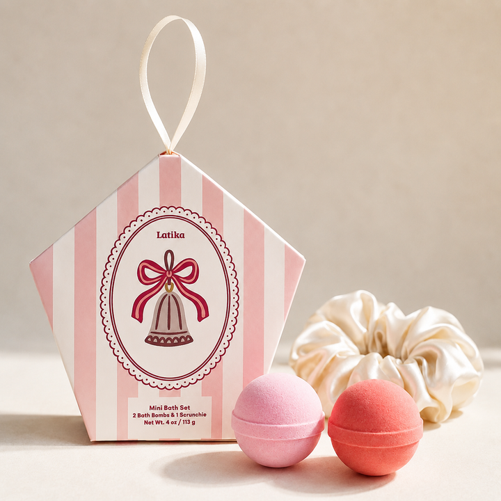 Pink striped pentagon ornament box with bell crest, two mini bath bombs and a satin scrunchie, a Christmas gift set