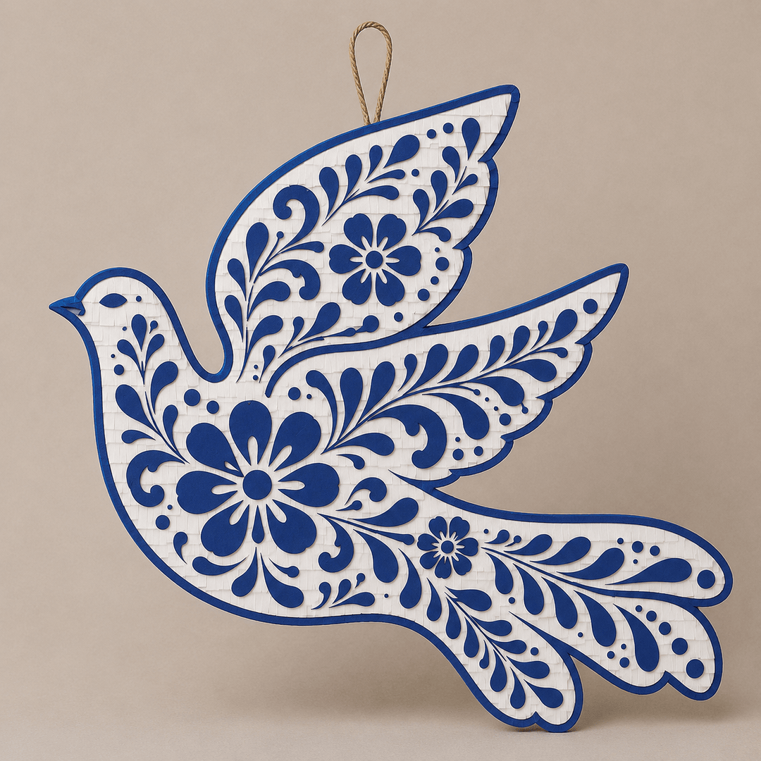Talavera-inspired dove piñata in cobalt blue and white florals with outstretched wings, a centerpiece for a wedding or fiesta