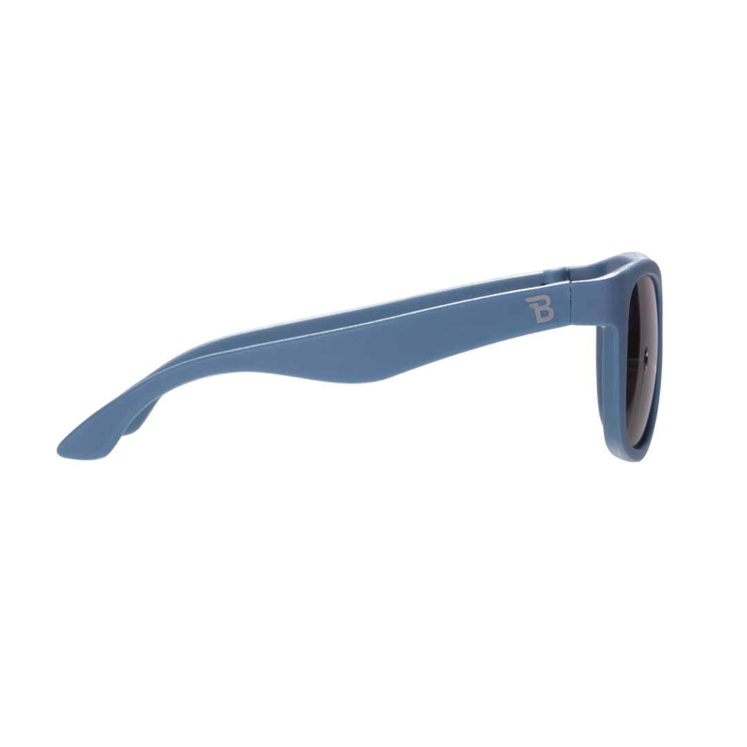 Side profile of blue eco aviator kids sunglasses showing the flexible temple arm and Babiators logo.