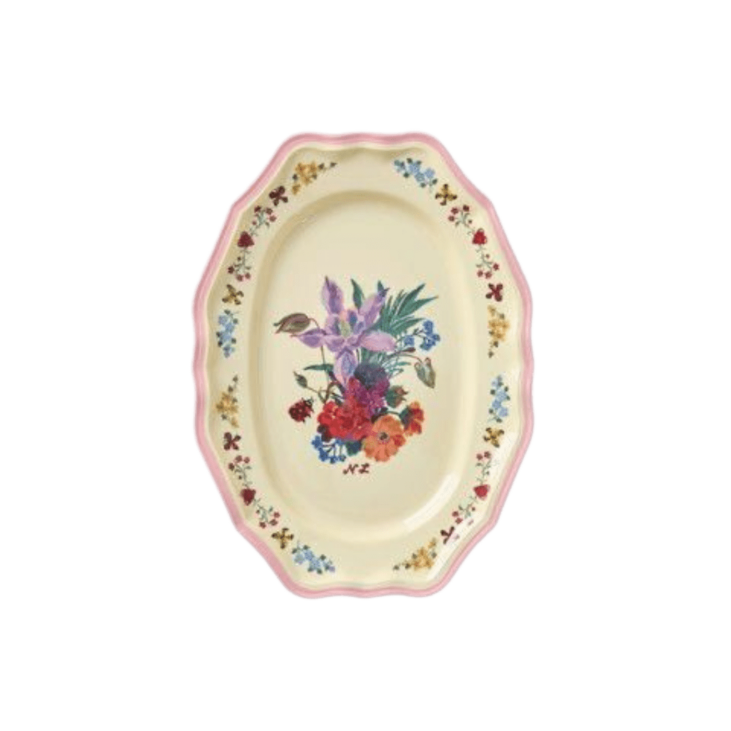 Small oval Nathalie Lété melamine serving dish with a purple and red floral bouquet and pink scalloped rim, top view
