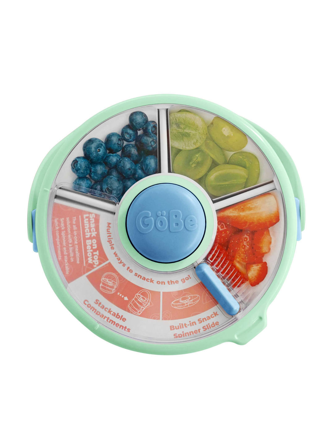 Overhead view of the four-section snack spinner lid holding blueberries, grapes, and strawberries