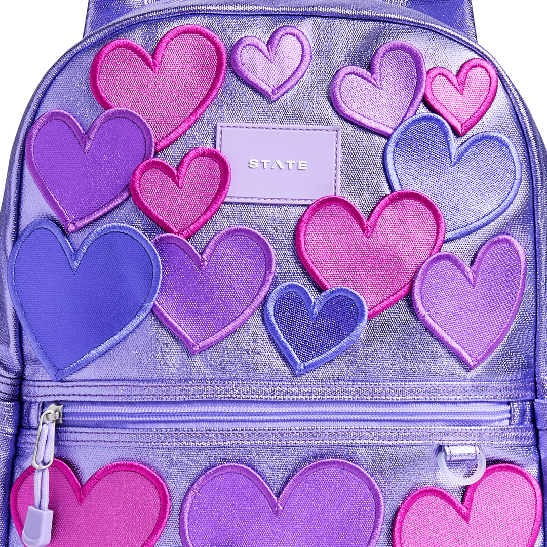 Close-up of the raised metallic heart appliques and STATE logo patch on the 3D Hearts Kane