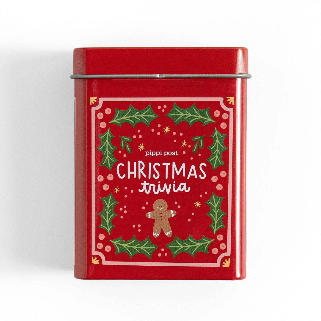 Red Christmas trivia tin with holly and gingerbread man artwork, a Christmas Eve game