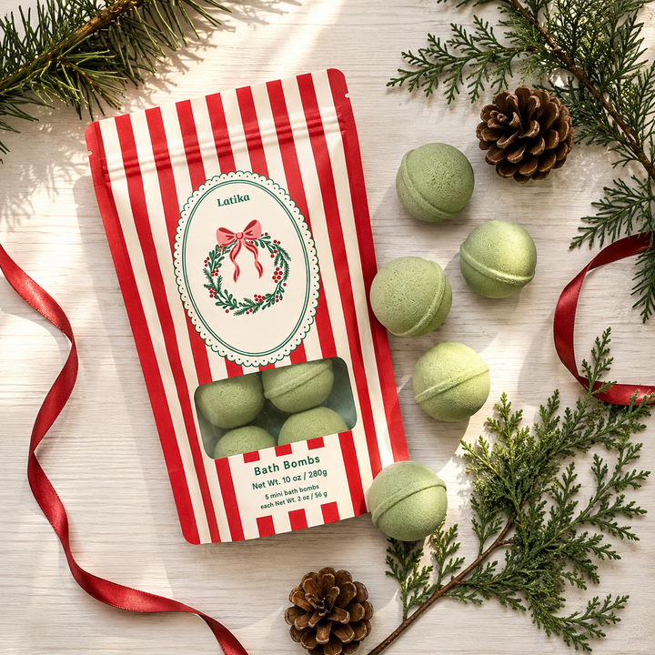 Flat lay of the red striped bath bomb pouch with green minis, red ribbon and pinecones for holiday gifting