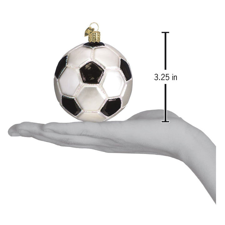 Soccer ball ornament on an open hand with a 3.25 inch scale marker beside it
