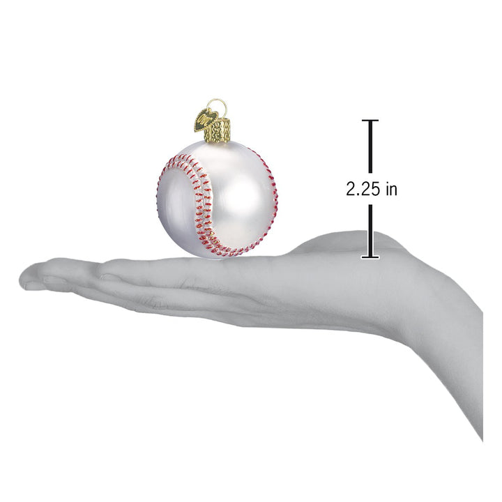 Baseball ornament on an open hand with a 2.25 inch scale marker beside it