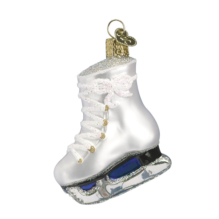 White ice skate ornament hanging on a lit Christmas tree