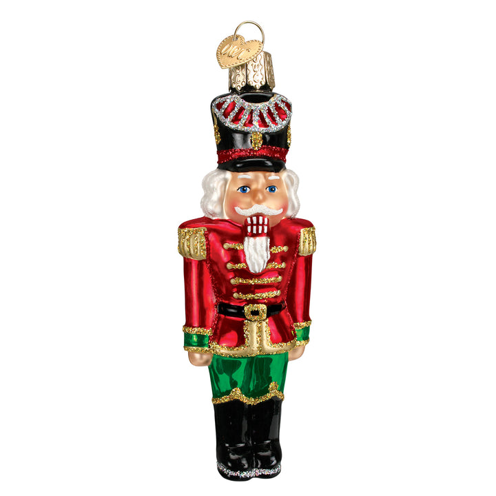 Front of the nutcracker general ornament in a red coat, green trousers, and tall hat, on white