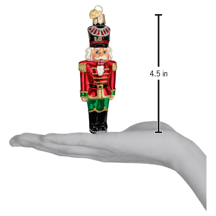 Nutcracker general ornament on an open palm beside a 4.5 inch height marker