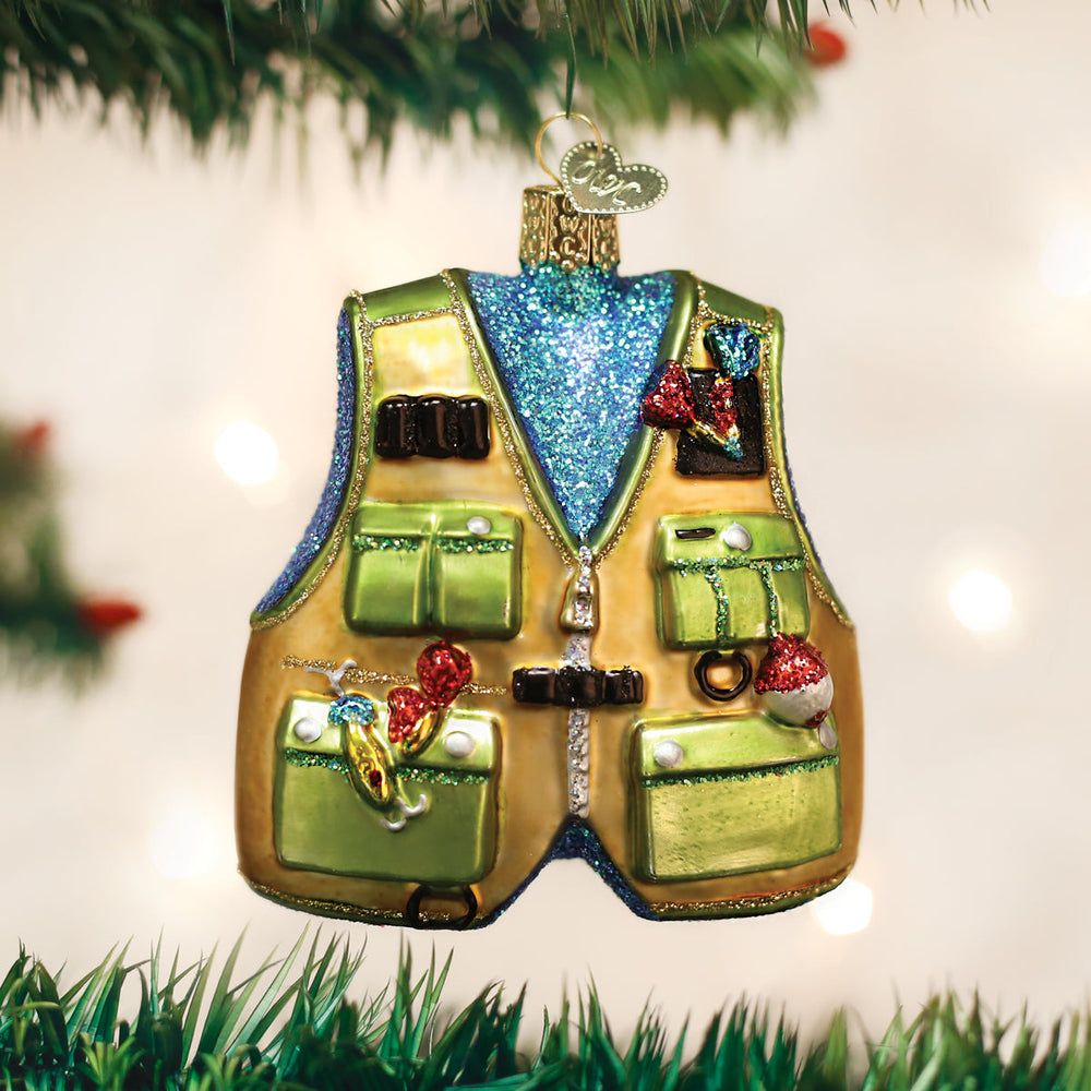Fishing vest ornament hanging on a lit Christmas tree with soft bokeh lights