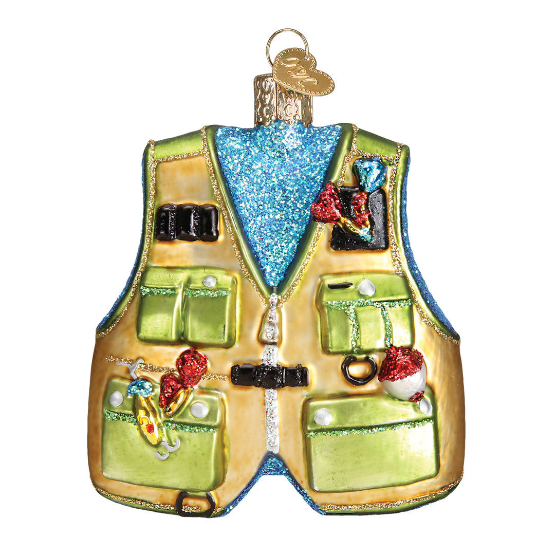 Front of the green and tan fishing vest glass ornament with pockets full of painted gear, on white