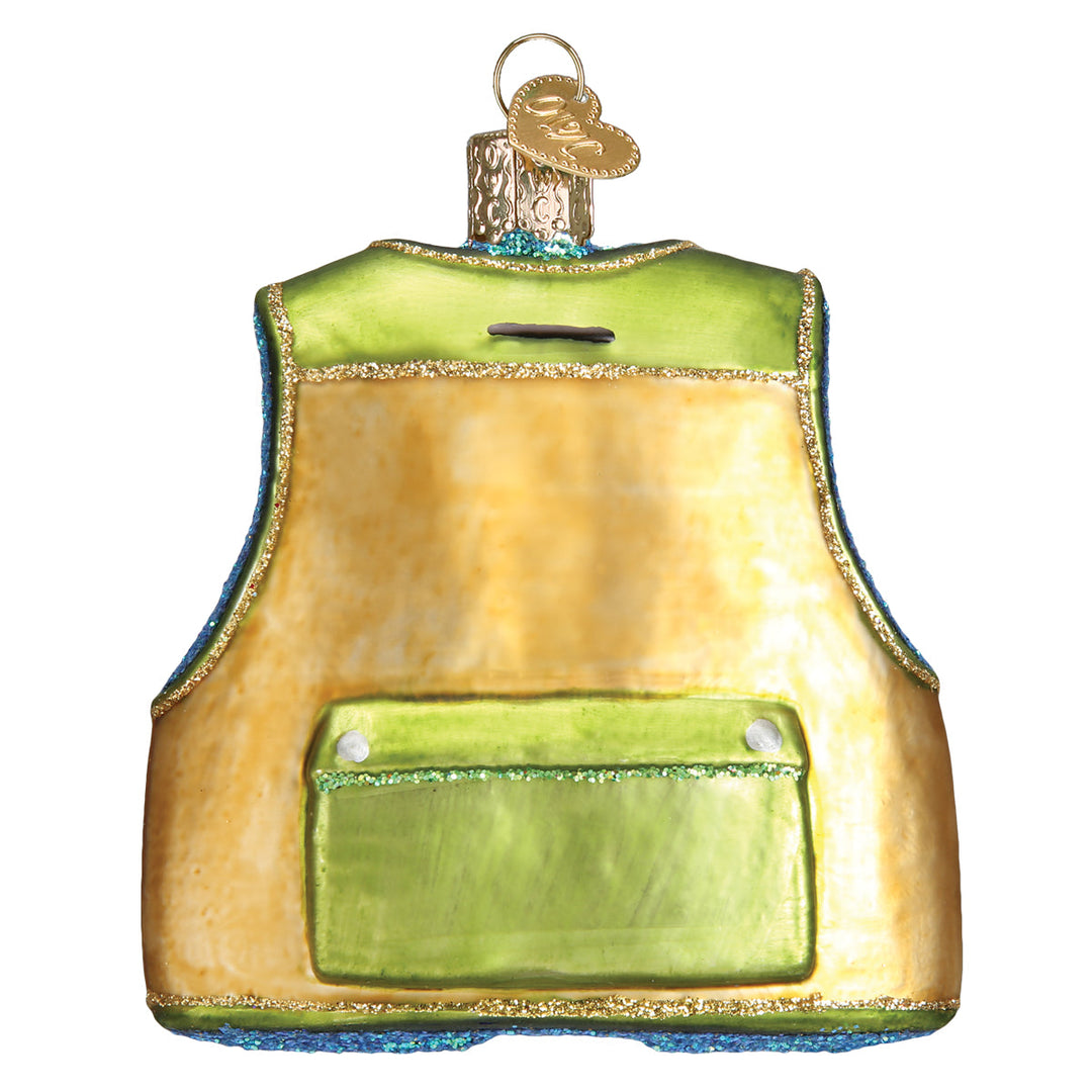 Back of the fishing vest ornament in tan glitter glass with a large back pocket, on white