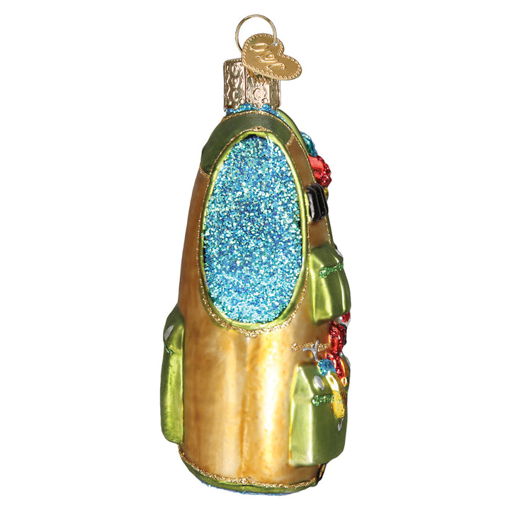 Side view of the fishing vest ornament showing its blue glitter lining, on white