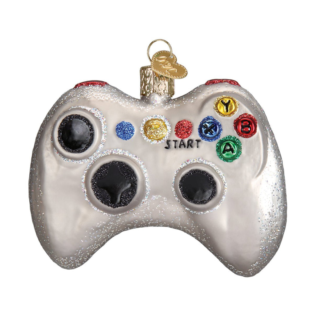 Video game controller ornament hanging on a lit Christmas tree
