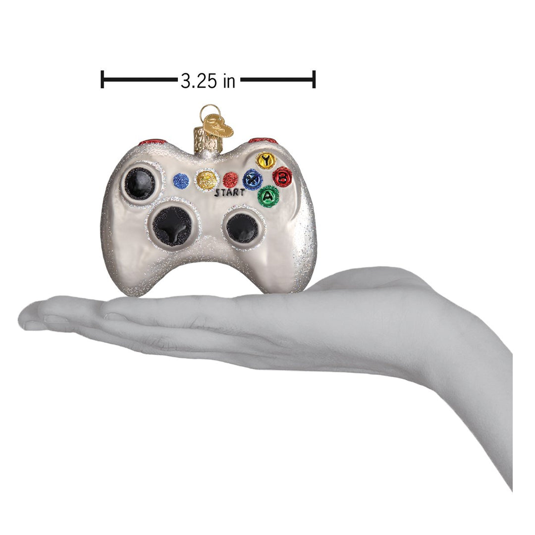 Video game controller ornament held in an open hand for scale