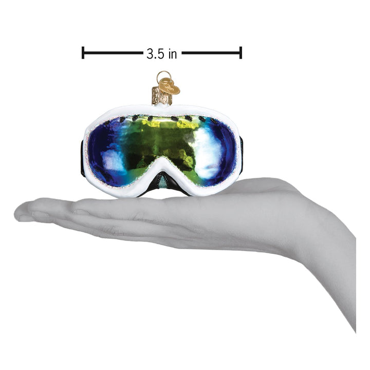 Ski goggles ornament on an open hand with a 3.5 inch scale marker above it