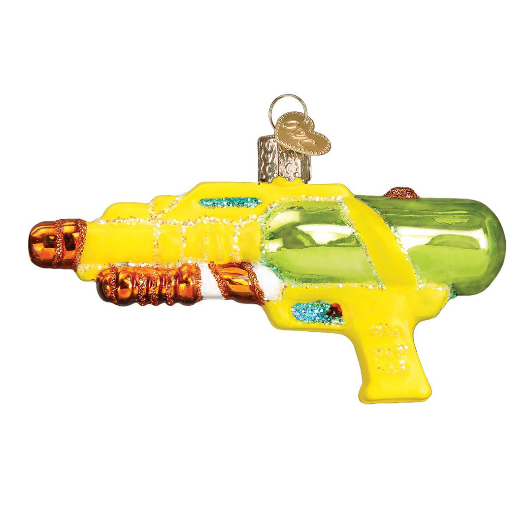 Side view of the yellow squirt gun ornament with a lime green water tank and orange grips, on white