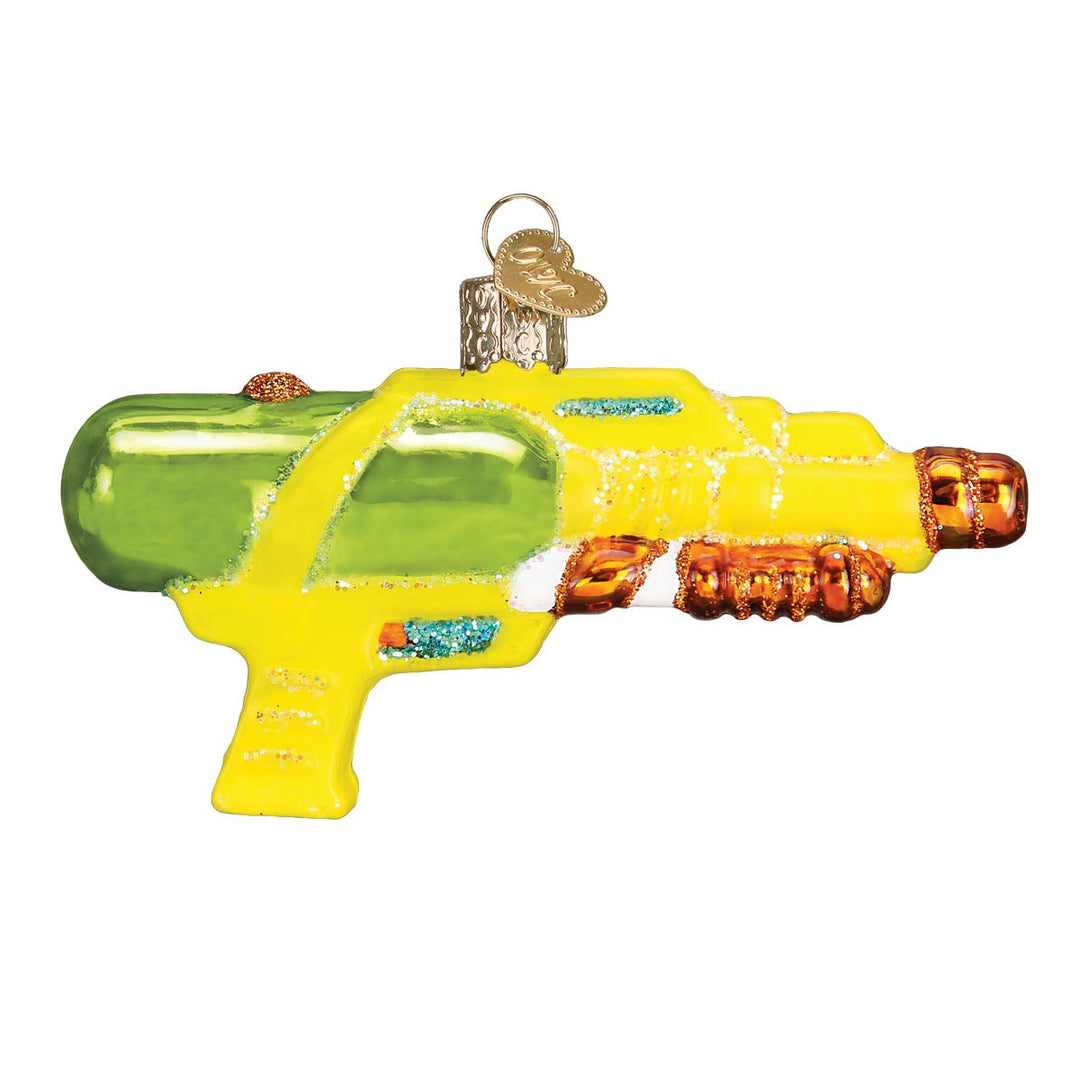 Opposite side of the squirt gun ornament showing the green tank and glittered orange handles, on white