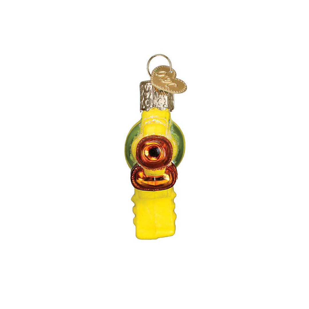 End view of the squirt gun ornament showing the round orange nozzle and yellow trigger, on white