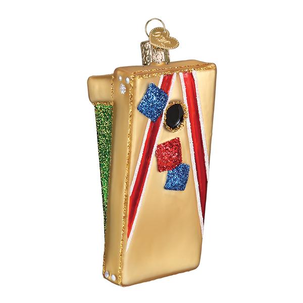 Cornhole board glass Christmas ornament in gold with a red stripe and red and blue bean bags, on white