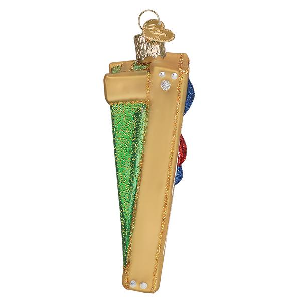 Side view of the slanted cornhole board ornament showing green glitter and bean bags, on white