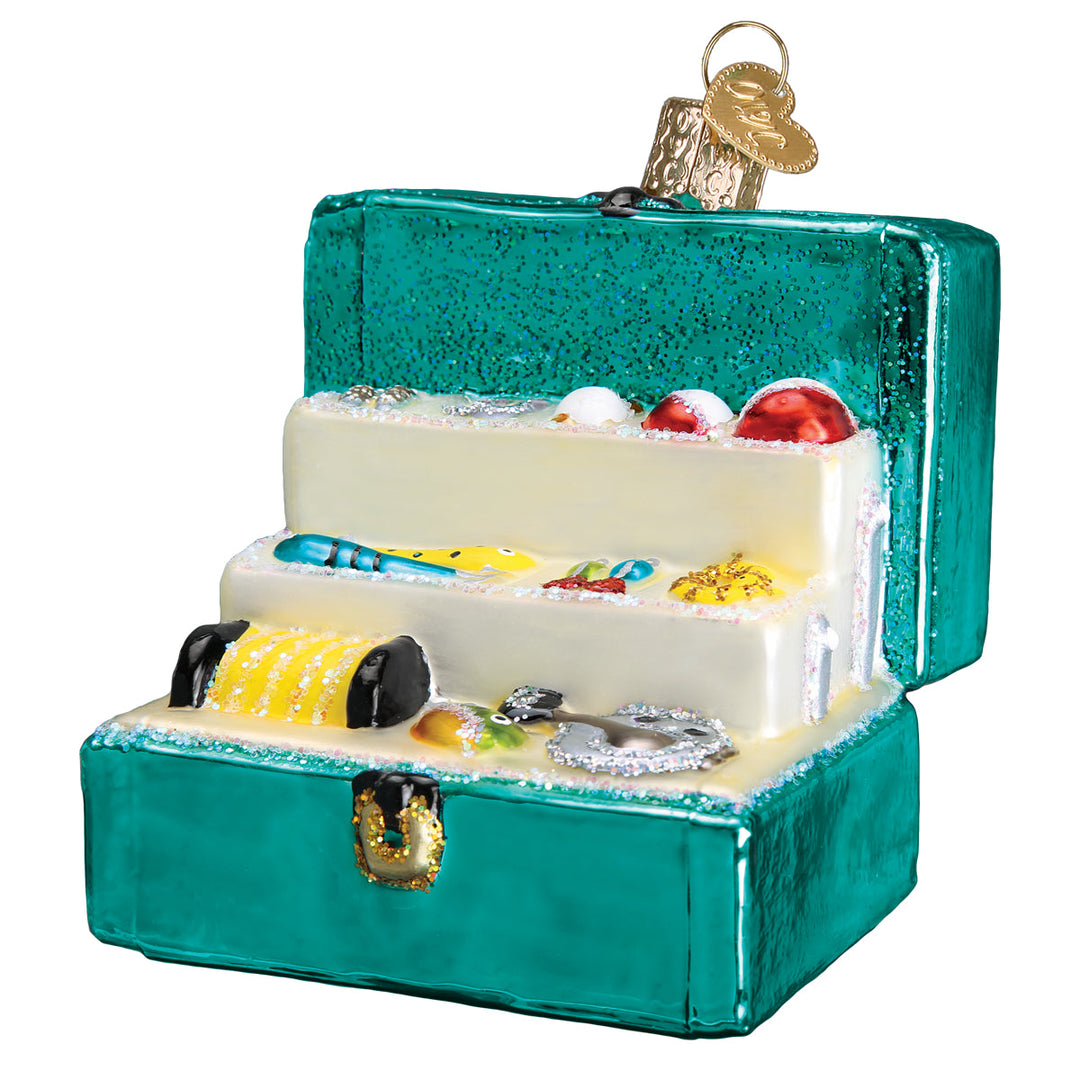 Front three-quarter view of the open teal tackle box glass ornament with a tray of tiny painted gear, on white
