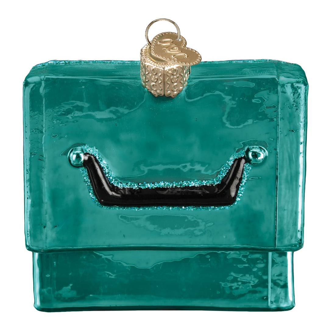 Back of the closed teal tackle box ornament showing its black lid handle, on white