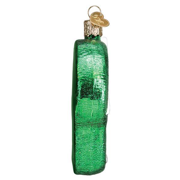 Side view of the putting green ornament showing its slim green glitter edge, on white