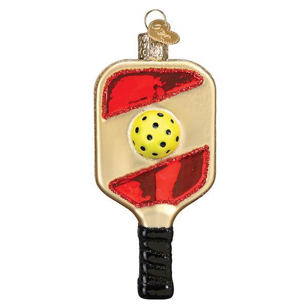 Front of the pickleball paddle ornament, gold with red stripes, a yellow ball, and black grip, on white