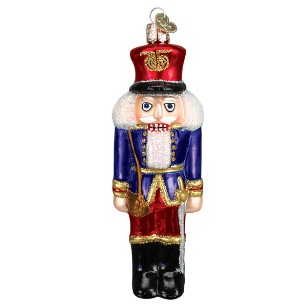 Front of the blue coat soldier nutcracker ornament with a red hat, gold trim, and black boots, on white