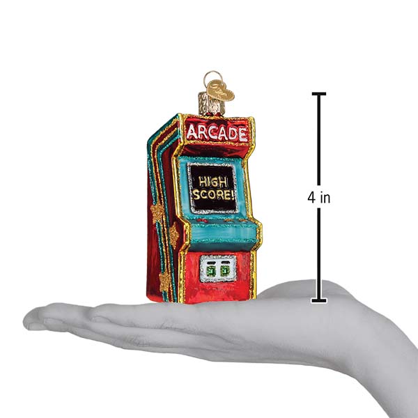 Arcade game ornament shown in an open hand for scale