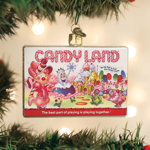 Candy Land game box ornament hanging on a Christmas tree with warm twinkle lights