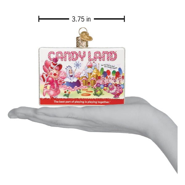 Candy Land box ornament on an open palm with a 3.75 inch width marker