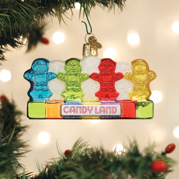 Candy Land Kids ornament hanging on a lit Christmas tree with twinkling lights