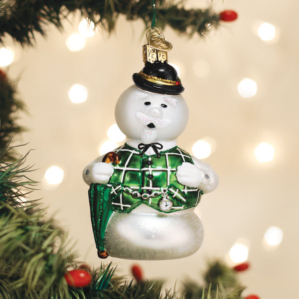 Sam the Snowman glass ornament singing, hanging on a lit Christmas tree