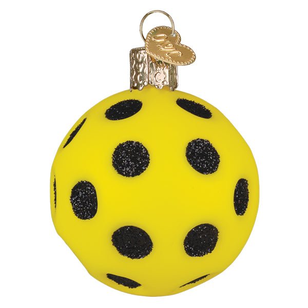 Rotated view of the yellow pickleball ornament with black holes wrapping around the ball, on white