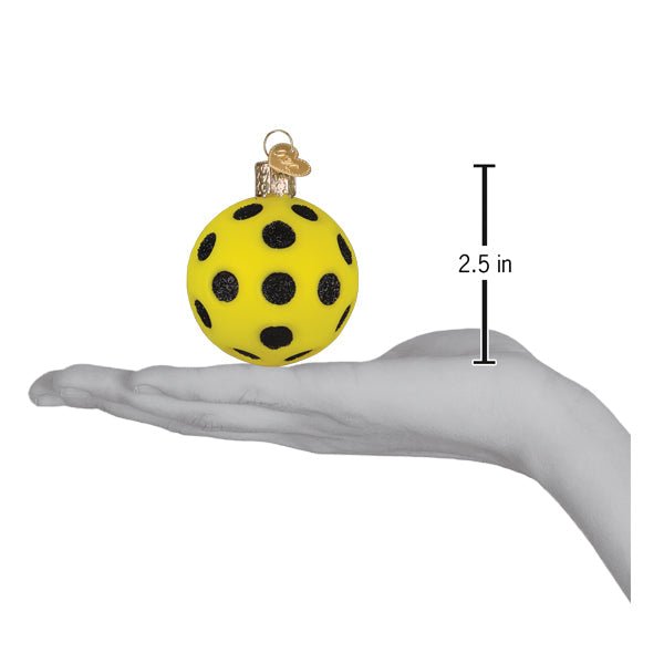 Pickleball ornament on an open palm beside a 2.5 inch height marker